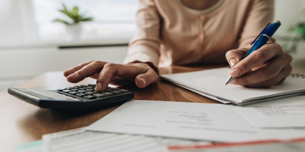A person using a calculator AI-generated content may be incorrect.